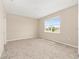 Neutral bedroom showcasing a sun-filled window and plush carpeting at 7337 Sw 89Th Ter, Ocala, FL 34481