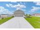 Exterior view of a home with a two-car garage and concrete driveway at 7337 Sw 89Th Ter, Ocala, FL 34481