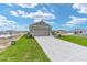 Exterior view of a home with a two-car garage and concrete driveway at 7337 Sw 89Th Ter, Ocala, FL 34481