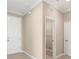 Hallway with neutral walls and tile flooring leading to a closet and other rooms at 7337 Sw 89Th Ter, Ocala, FL 34481