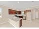 Well-lit kitchen featuring brown cabinets, stainless steel appliances, and a speckled granite countertop at 7337 Sw 89Th Ter, Ocala, FL 34481