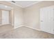 Living room with neutral walls, plush carpet, and access to other rooms at 7337 Sw 89Th Ter, Ocala, FL 34481