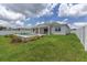 Charming backyard with in-ground pool, patio and white fence, ideal for outdoor entertaining at 7624 Sw 60Th St, Ocala, FL 34474