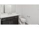 Bathroom featuring a black cabinet with a white countertop and a toilet at 7624 Sw 60Th St, Ocala, FL 34474