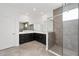 A contemporary bathroom featuring dual vanities, large mirrors, and a stylish glass-enclosed shower at 7624 Sw 60Th St, Ocala, FL 34474