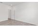 A bedroom with neutral tile flooring, white walls, and a doorway leading to another room at 7624 Sw 60Th St, Ocala, FL 34474