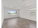 A light-filled bedroom features neutral walls and tile flooring with large windows for ample natural light at 7624 Sw 60Th St, Ocala, FL 34474