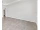 A spacious bedroom with neutral walls, tile floors, and a recessed ceiling at 7624 Sw 60Th St, Ocala, FL 34474