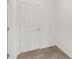 A white interior door with matching trim in a bright, neutral hallway at 7624 Sw 60Th St, Ocala, FL 34474