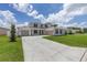 Charming two-story home displays a large driveway, a well-kept lawn, and a convenient three-car garage at 7624 Sw 60Th St, Ocala, FL 34474