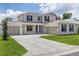 Inviting two-story home boasts a manicured lawn, three-car garage, and classic architectural elements for curb appeal at 7624 Sw 60Th St, Ocala, FL 34474