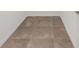 Close up on newly-installed neutral, large format tile flooring with white baseboards at 7624 Sw 60Th St, Ocala, FL 34474