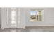 Bright foyer boasts tile flooring, a view of the front yard, and a window providing ample natural light at 7624 Sw 60Th St, Ocala, FL 34474