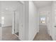 Bright hallway featuring neutral carpeting and white walls, leading to various rooms in the home at 7624 Sw 60Th St, Ocala, FL 34474