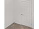 Clean hallway showcasing neutral tile flooring and a white paneled door for classic appeal at 7624 Sw 60Th St, Ocala, FL 34474