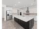 Modern open kitchen with a large center island, stainless steel appliances, and white cabinetry, offering ample counter space at 7624 Sw 60Th St, Ocala, FL 34474