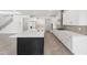 A spacious kitchen features white cabinetry, a large island, stainless steel appliances, and a stylish backsplash at 7624 Sw 60Th St, Ocala, FL 34474