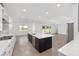 A modern kitchen with stainless steel appliances, a large island, and sliding glass doors to the outdoor area at 7624 Sw 60Th St, Ocala, FL 34474