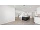 Open floor plan featuring tile flooring, white walls, a kitchen island, and a staircase at 7624 Sw 60Th St, Ocala, FL 34474