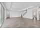 An open living room with tile floors, recessed lighting, sliding glass doors, and staircase to the second level at 7624 Sw 60Th St, Ocala, FL 34474