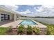 Beautiful in-ground pool with modern tile accents and manicured landscaping at 7624 Sw 60Th St, Ocala, FL 34474