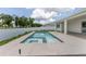 Backyard features a serene in-ground pool with spa, enclosed by a modern white fence at 7624 Sw 60Th St, Ocala, FL 34474