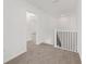 Upstairs landing with neutral carpet, white walls, and a railing at 7624 Sw 60Th St, Ocala, FL 34474
