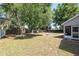 Expansive backyard with mature trees, a fire pit, and access to a screened-in porch at 8053 Sw 62Nd Ave, Ocala, FL 34476