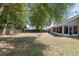 Large backyard with shade trees, a fire pit, and an enclosed sunroom at 8053 Sw 62Nd Ave, Ocala, FL 34476