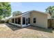 The exterior features an enclosed porch, with a spacious yard and wood fence at 8053 Sw 62Nd Ave, Ocala, FL 34476