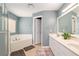 Bathroom with a double sink vanity, soaking tub, and tiled floors at 8053 Sw 62Nd Ave, Ocala, FL 34476