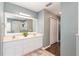 Bathroom featuring a double vanity, shower, and linen closet at 8053 Sw 62Nd Ave, Ocala, FL 34476