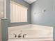 Corner bathtub with chrome fixtures and white tile surround at 8053 Sw 62Nd Ave, Ocala, FL 34476