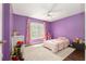 Bedroom with purple walls, area rug, and a ceiling fan at 8053 Sw 62Nd Ave, Ocala, FL 34476