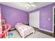 Bright bedroom features hardwood floors, a ceiling fan, and playful decor at 8053 Sw 62Nd Ave, Ocala, FL 34476