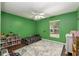 Green bedroom features hardwood floors, a ceiling fan, and large window at 8053 Sw 62Nd Ave, Ocala, FL 34476