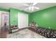 Green bedroom featuring hardwood floors, a ceiling fan, and built-in shelving at 8053 Sw 62Nd Ave, Ocala, FL 34476