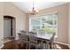 Charming dining room with a wooden table, elegant chandelier, and a large window providing natural light at 8053 Sw 62Nd Ave, Ocala, FL 34476