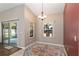 Bright dining room with chandelier lighting, tile flooring, and view to outside at 8053 Sw 62Nd Ave, Ocala, FL 34476