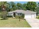 Lovely single-story home with a manicured lawn, mature landscaping, and a two-car garage providing a welcoming curb appeal at 8053 Sw 62Nd Ave, Ocala, FL 34476