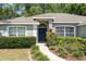 Inviting home exterior with a neatly landscaped front yard, arched windows, and a pathway leading to the front door at 8053 Sw 62Nd Ave, Ocala, FL 34476