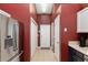 Hallway view features access to the kitchen, front door, and closet, with tile flooring throughout at 8053 Sw 62Nd Ave, Ocala, FL 34476