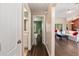 Hallway featuring wood floors, a view of the living room, and a bathroom at 8053 Sw 62Nd Ave, Ocala, FL 34476