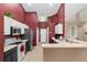 This kitchen features a stainless steel refrigerator and microwave, white upper cabinets, and dark lower cabinets at 8053 Sw 62Nd Ave, Ocala, FL 34476
