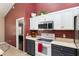 This kitchen shows stainless steel appliances, contrasting wall and cabinet colors, and plenty of natural light at 8053 Sw 62Nd Ave, Ocala, FL 34476