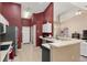 This kitchen offers contrasting wall and cabinet colors, as well as stainless steel appliances, and an island at 8053 Sw 62Nd Ave, Ocala, FL 34476