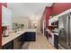 This kitchen offers stainless steel appliances, white cabinets, dark cabinets, and a tile floor at 8053 Sw 62Nd Ave, Ocala, FL 34476