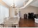 Open-concept living space features hardwood floors, neutral walls, and a view into the dining and living areas at 8053 Sw 62Nd Ave, Ocala, FL 34476
