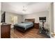 Main bedroom with a king bed, ceiling fan, television, and windows with natural light at 8053 Sw 62Nd Ave, Ocala, FL 34476