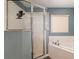 White tiled shower with clear glass door, rainfall shower head, and built-in bench at 8053 Sw 62Nd Ave, Ocala, FL 34476